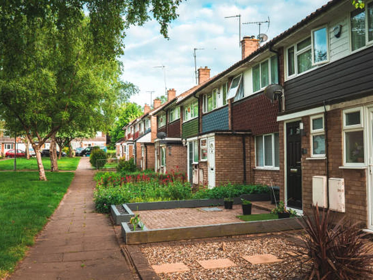 Exterior masonry painting on 1960s brick terraced houses in Hereford