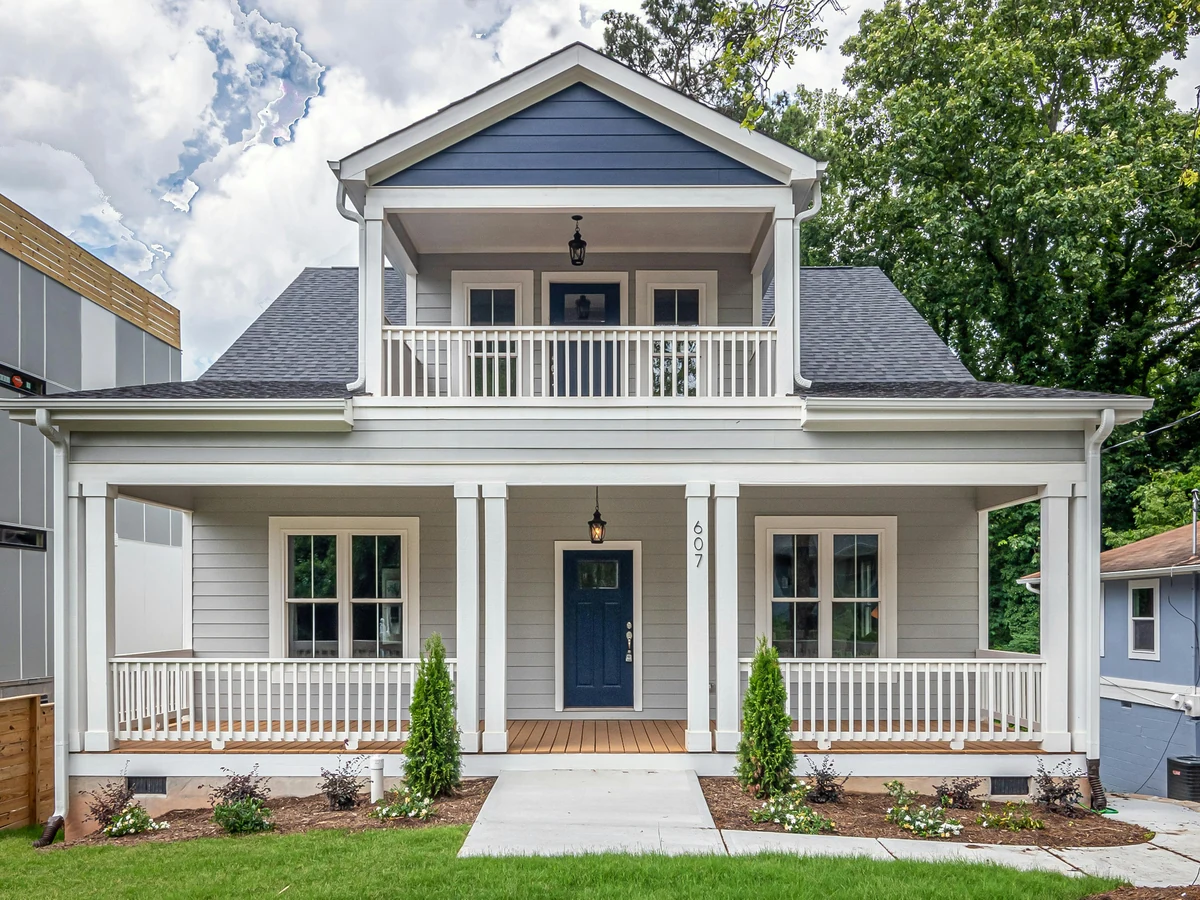 Exterior painting of white two-storey house in Hereford by Hereford Painters