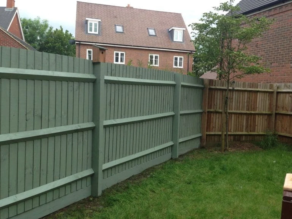 Green wooden garden fence freshly painted in Hereford by Hereford Painters