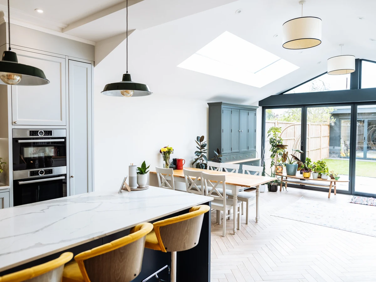 Modern open-plan kitchen with painted cabinets by Hereford Painters