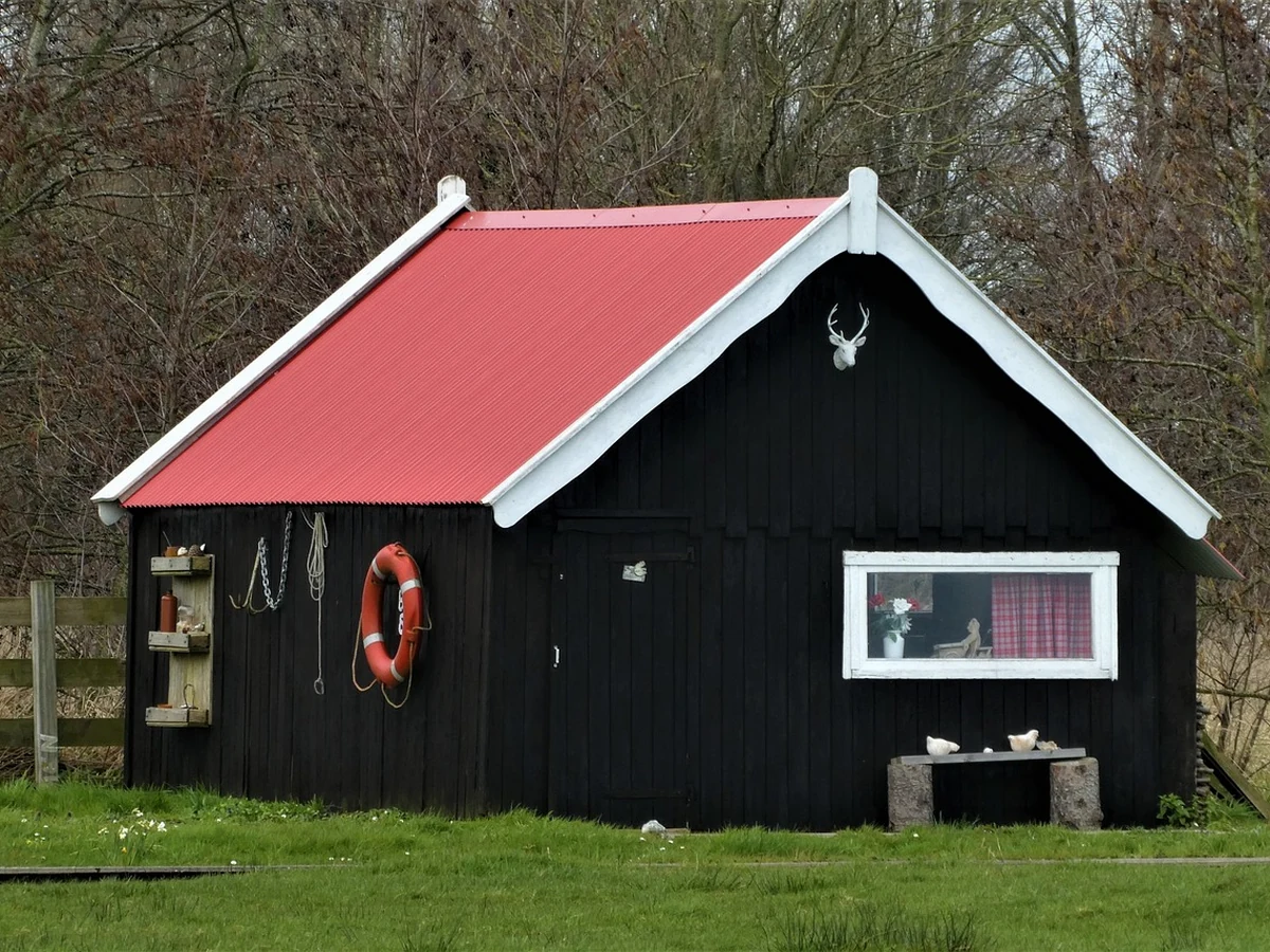 Shed painting in Hereford by Hereford Painters, black wooden outbuilding with professional timber treatment